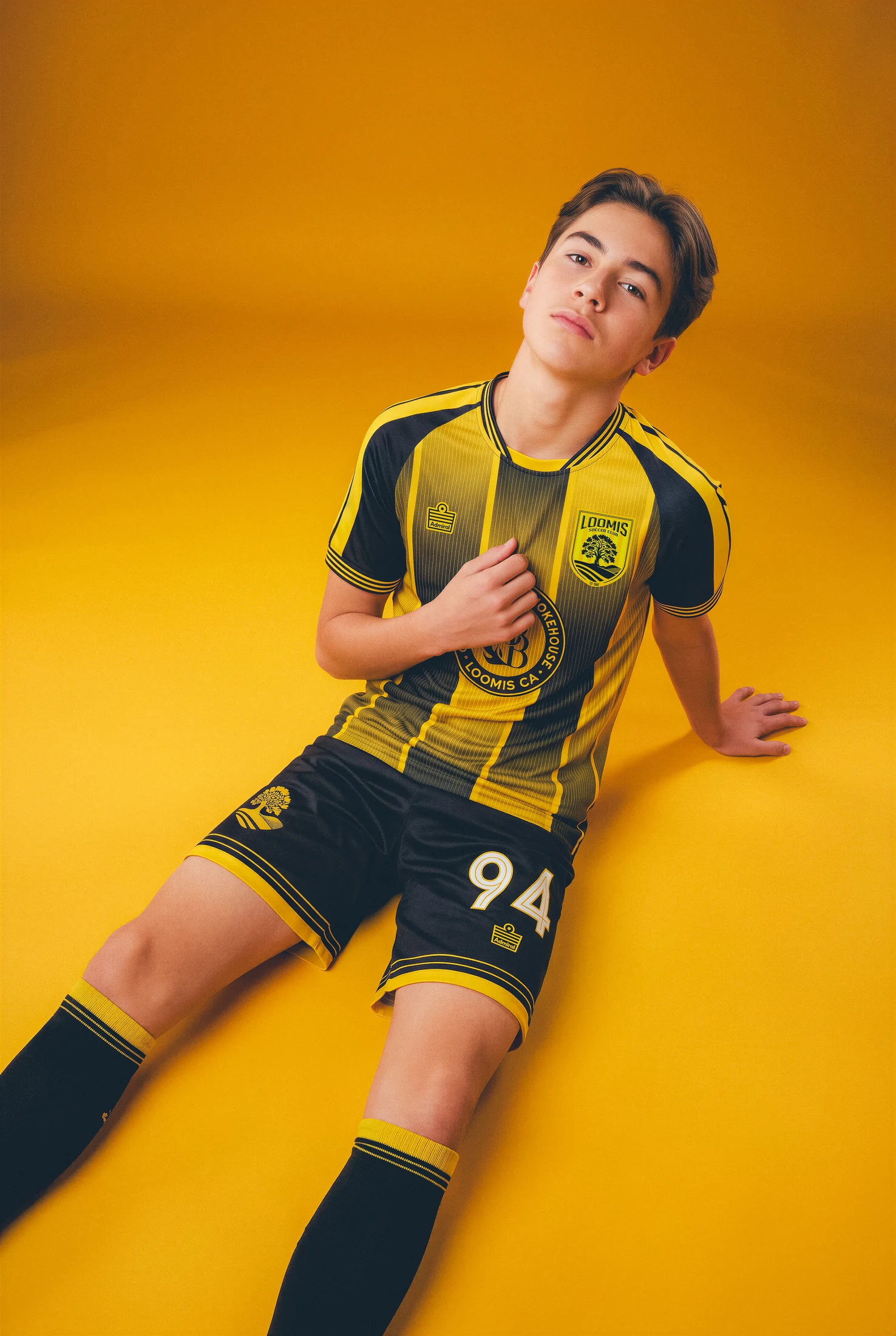 Loomis player seated in the black-and-gold home kit